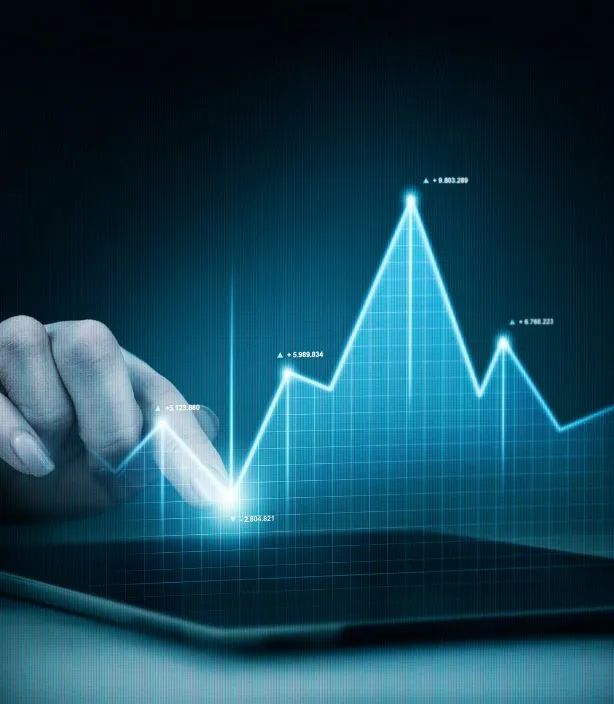 A hand points at a glowing line graph showing real estate investment trends on a blue grid.