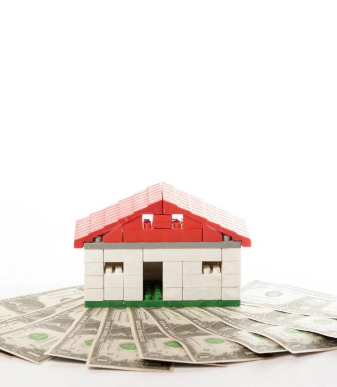 A small house sits on dollar bills, reflecting vibrant properties in Pakistan opportunities.